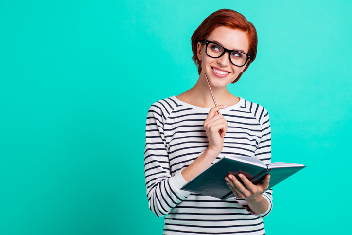 Woman thinking about writing listicles and great topics for her business.